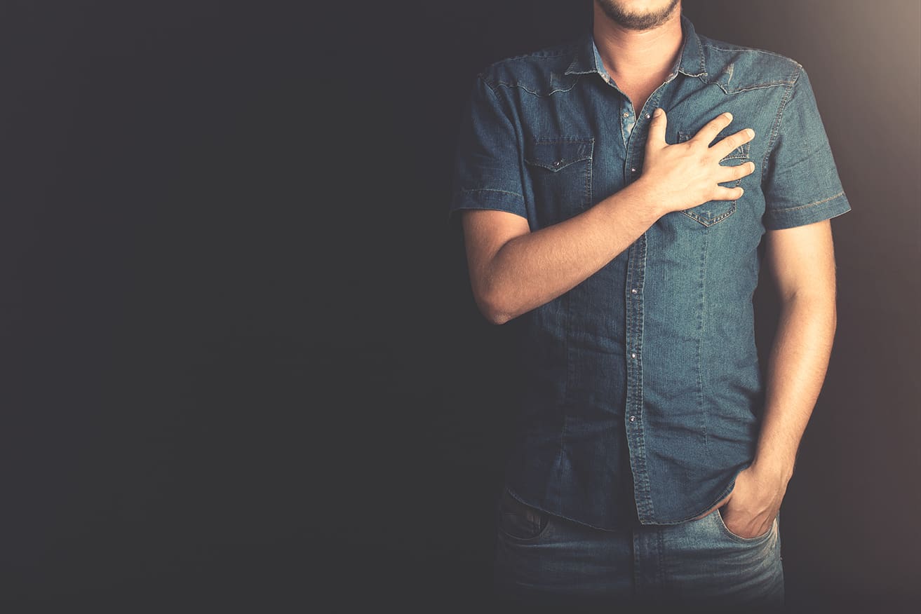 man holding chest