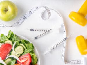 healthy food and a tape measure on a table to illustrate how healthy eating aids semaglutide for weight loss