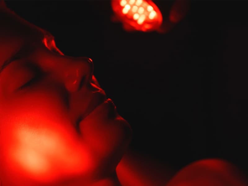 close-up of woman's face during red light therapy