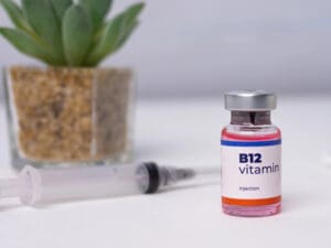 bottle of vitamin B12 on a table to illustrate benefits of vitamin injections