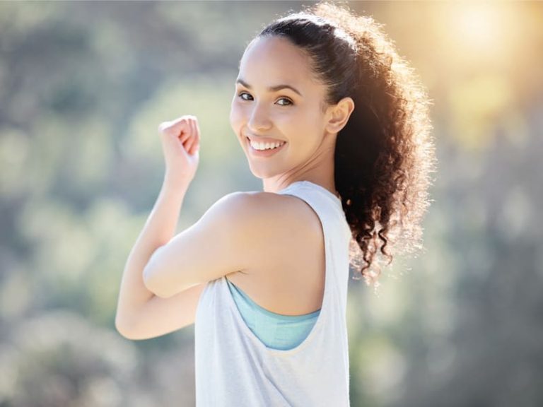 sporty young woman showing high energy to illustrate benefits of B12 shots