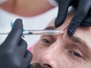 Male patient receiving anti-wrinkle injection of an aesthetic filler
