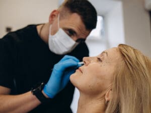 Male marking patient's face for a non-surgical cosmetic injectable procedure